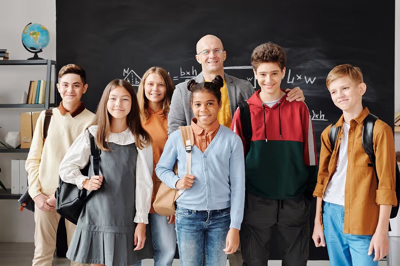 Group Of Well-Behaved Children Inside A Classroom.